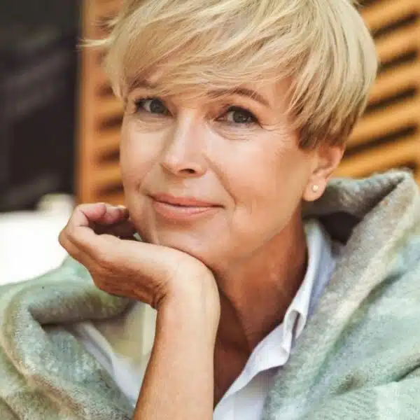 mature woman sitting outside with coffee