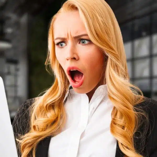 woman business laptop shocked