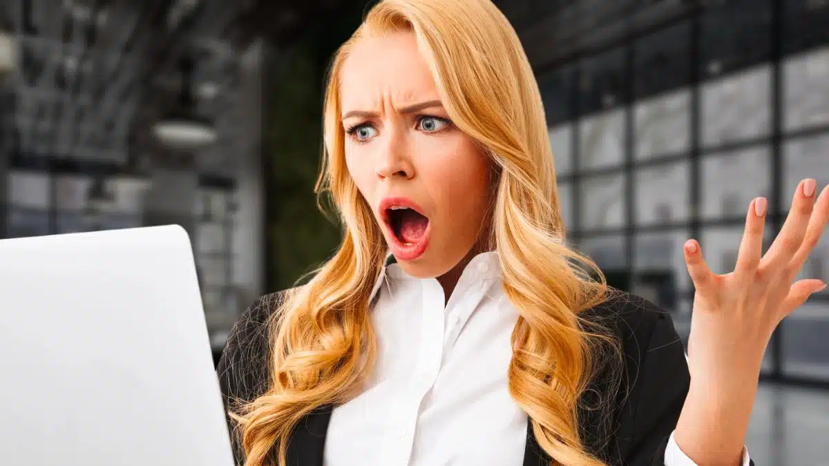 woman business laptop shocked