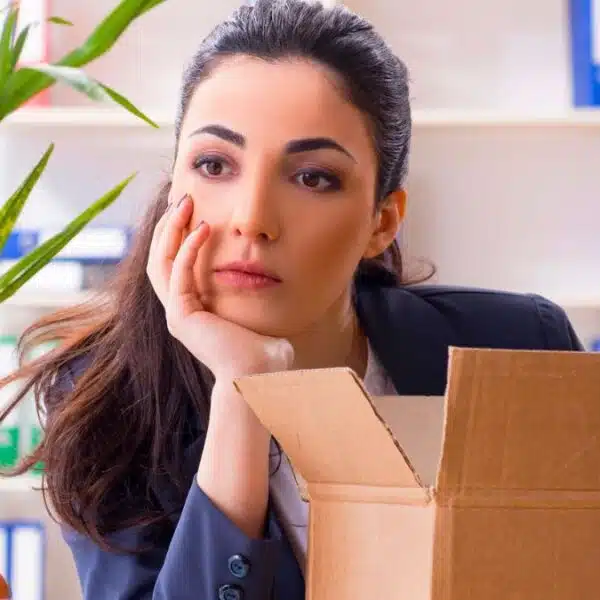 woman sad at work with a box