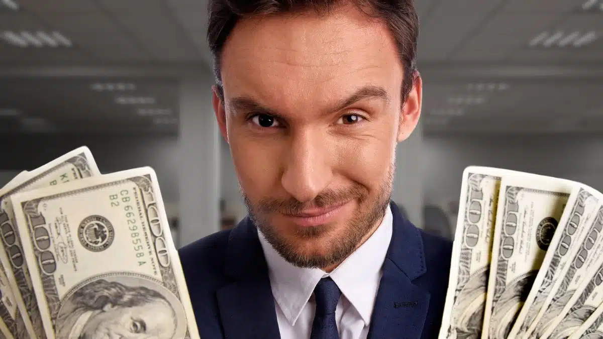 business man holding cash in office