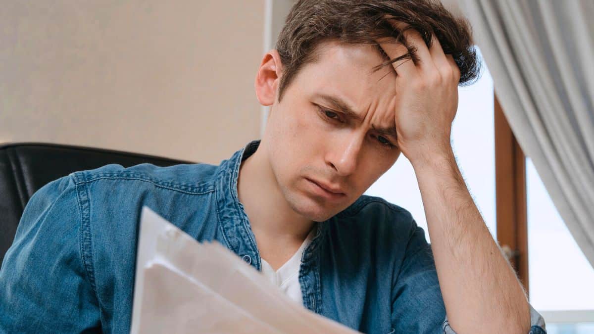 man worried looking at documents at desk