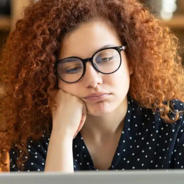 redhead worry laptop glasses