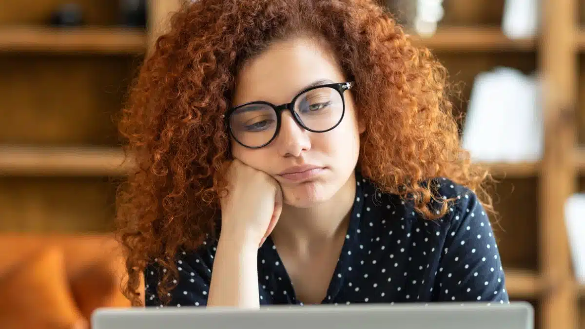 redhead worry laptop glasses