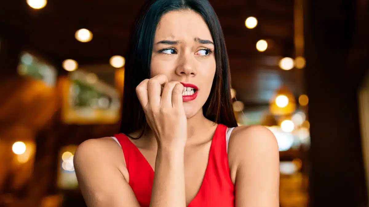 woman nervous biting fingers