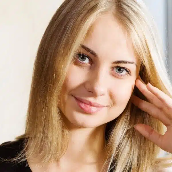 blonde woman smiling thinking in office