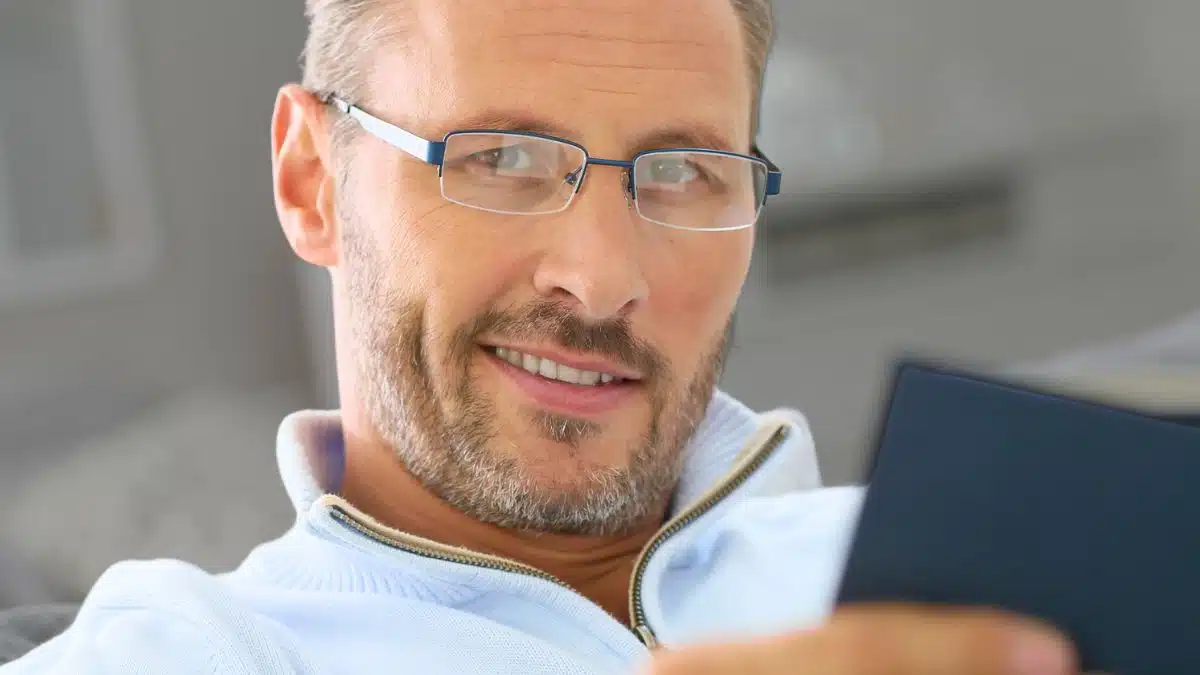 man glasses reading a book
