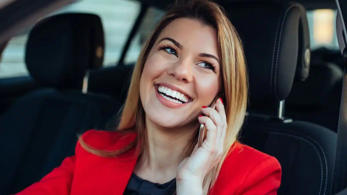 woman female driving a car red