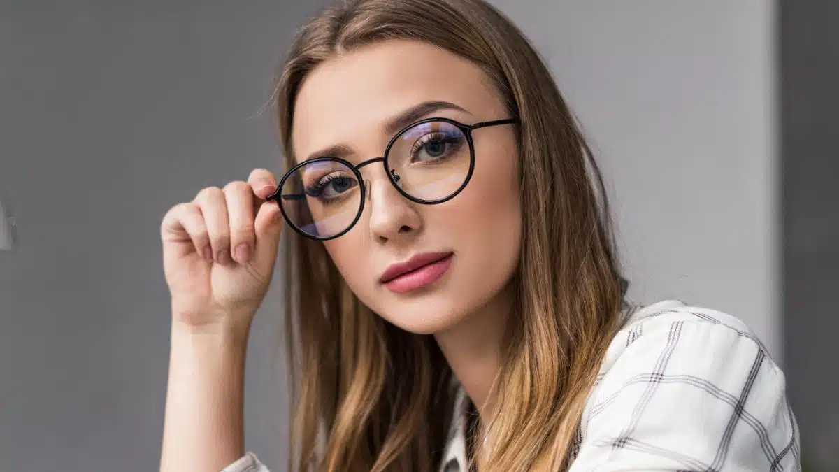 woman glasses sitting at a desk