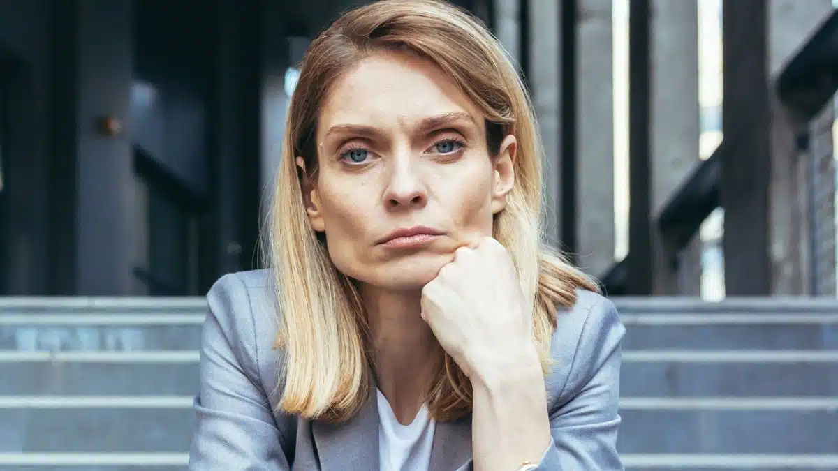 business woman sitting on steps sad