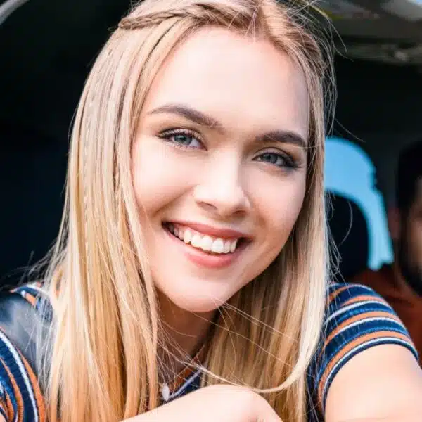 friends driving in a car smiling