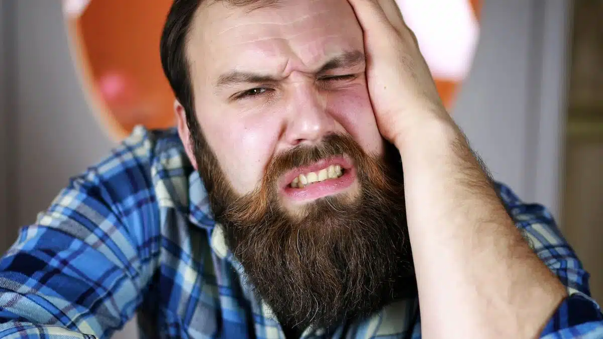 man with beard bored tired