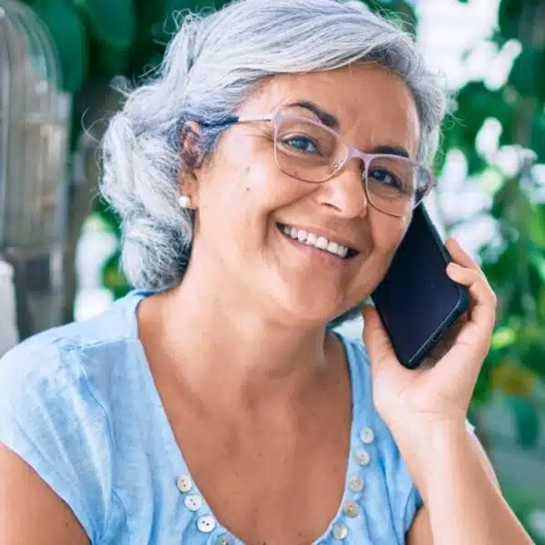 mature woman on phone laptop outside