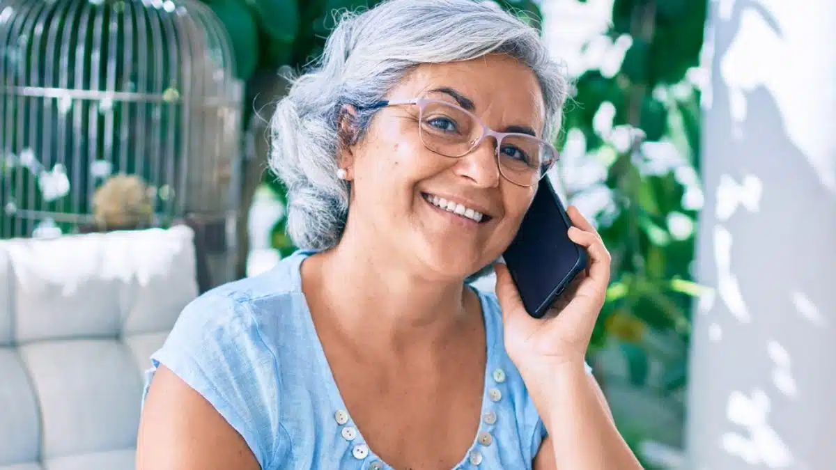 mature woman on phone laptop outside