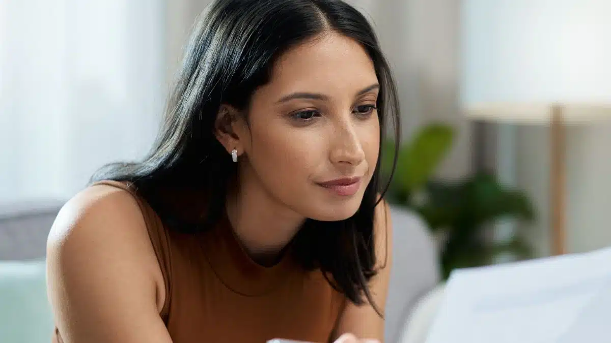 woman brown top documents budget