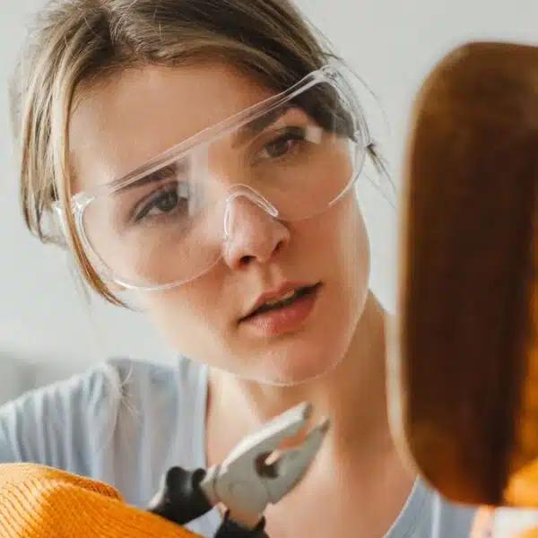 woman fixing a chair with screw driver