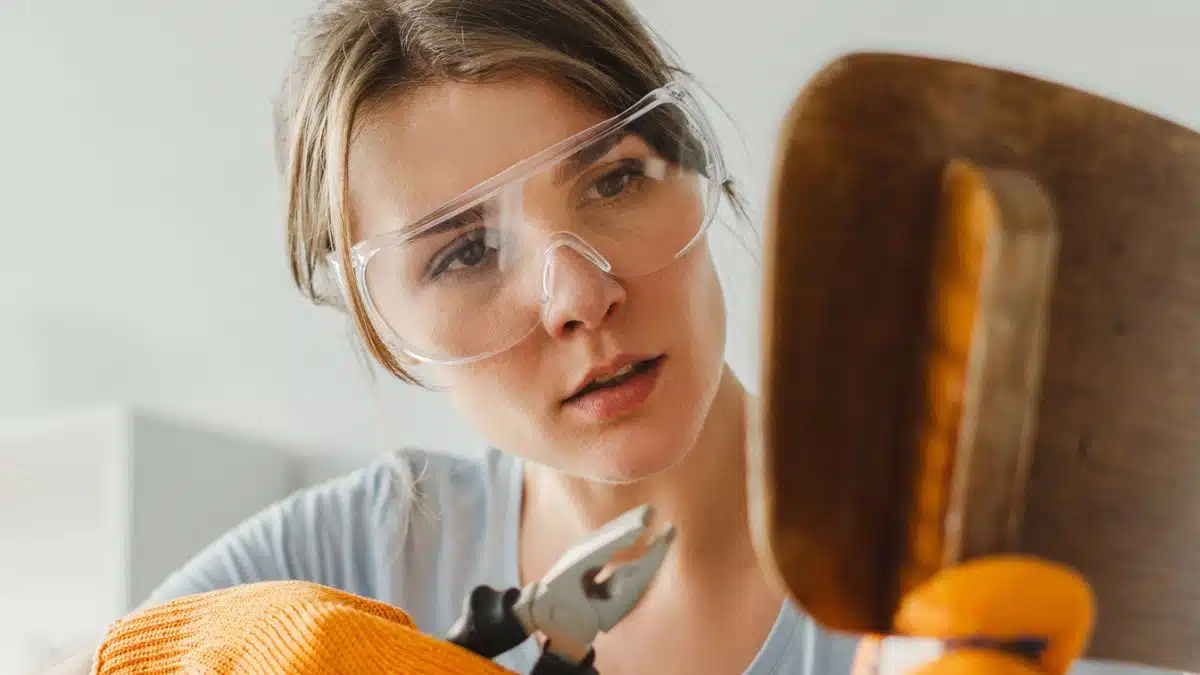woman fixing a chair with screw driver