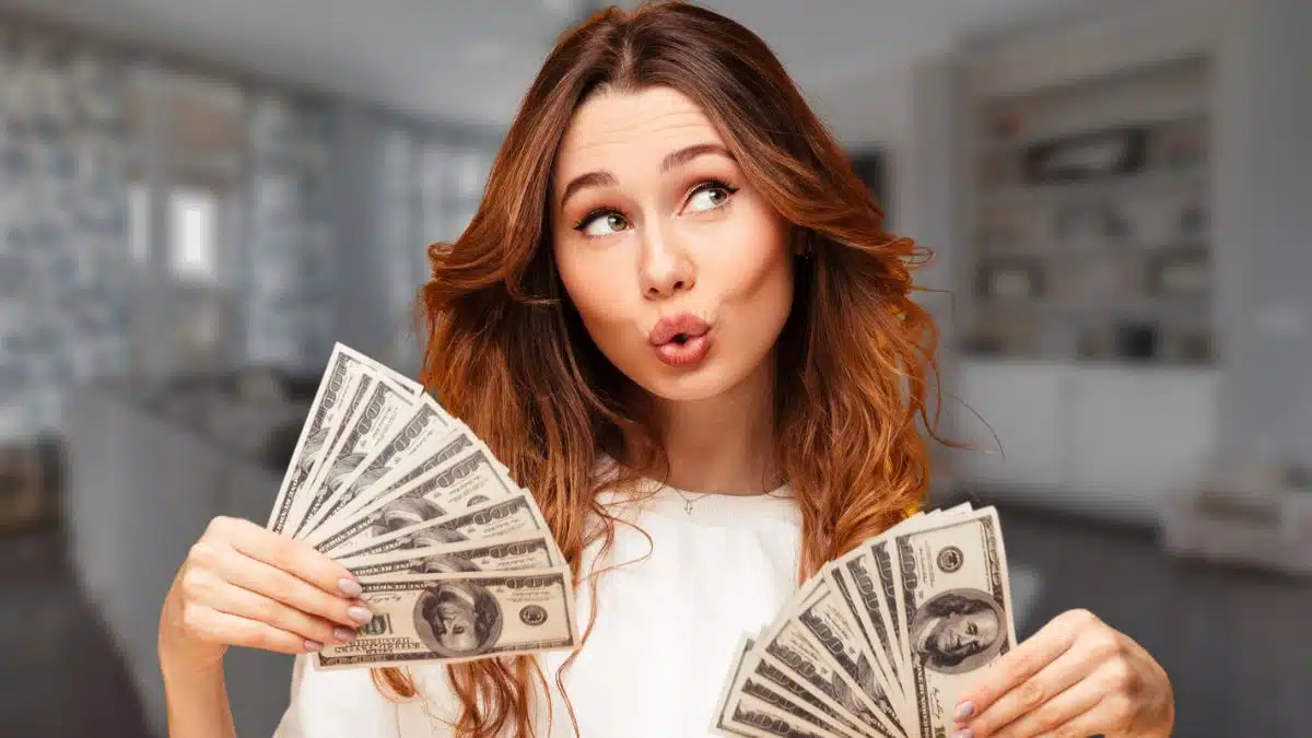 woman happy holding money cash