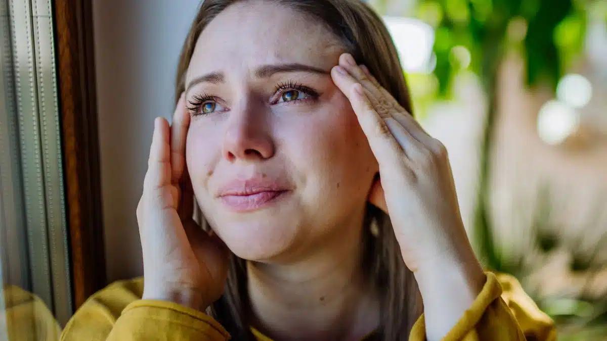 woman in yellow worried sad crying