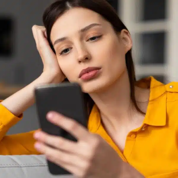 woman on her phone sad