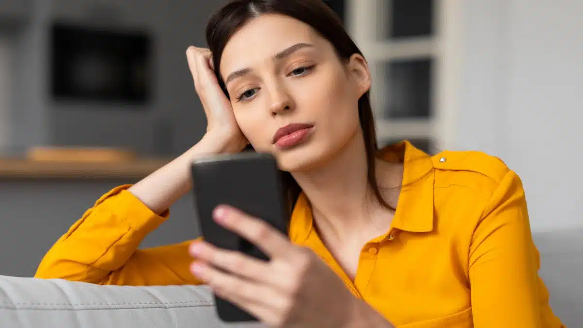 woman on her phone sad
