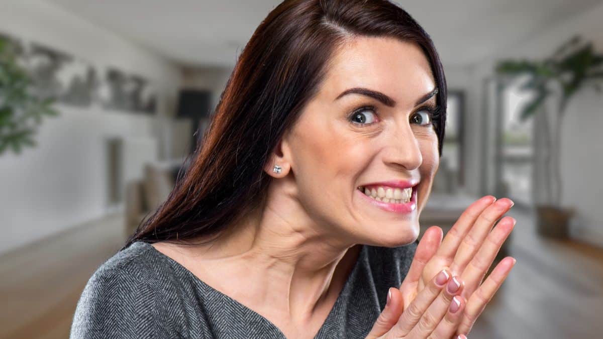 woman sneaky happy at home