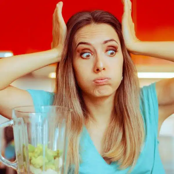 woman stunned blender in kitchen