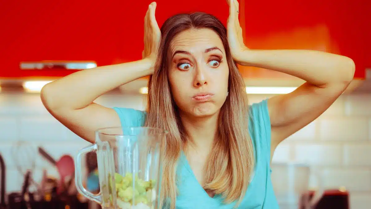 woman stunned blender in kitchen