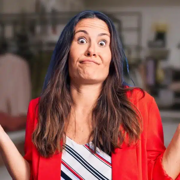 woman confused hands up red shirt
