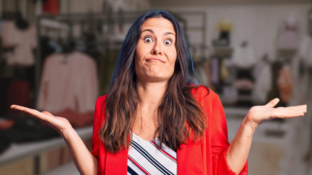 woman confused hands up red shirt