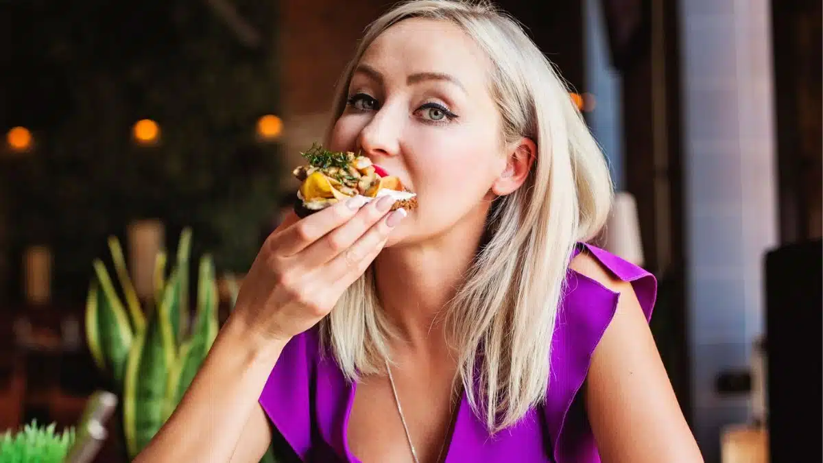 woman eating food in fancy restaurant