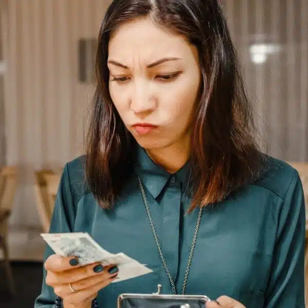 woman restaurant looking at bill money