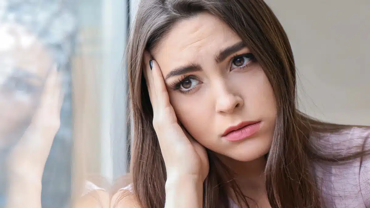woman sad looking out the window