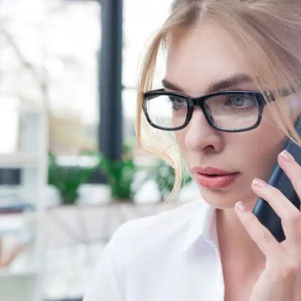 woman talking on the phone glasses in the office