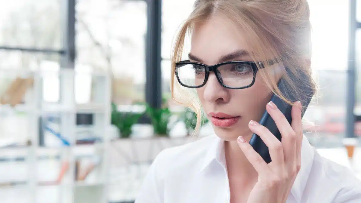 woman talking on the phone glasses in the office