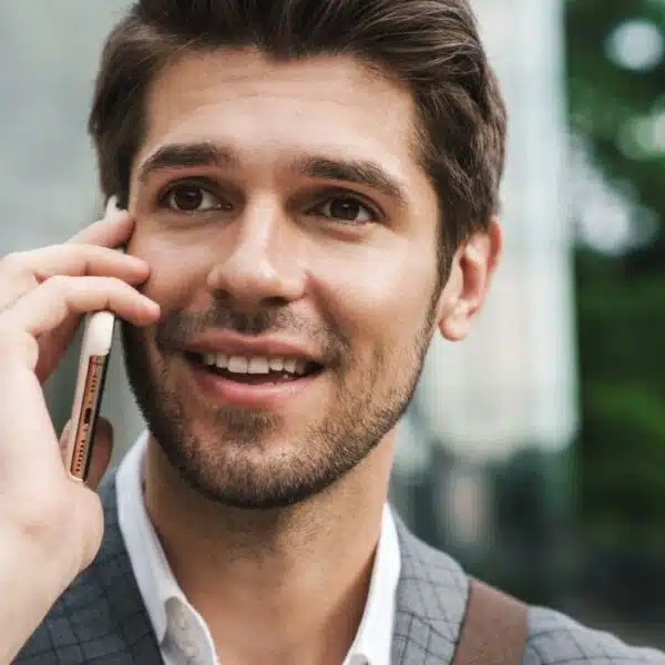young man suit holding phone talking