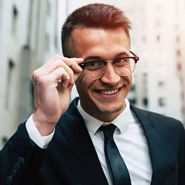 business man smirking glasses downtown