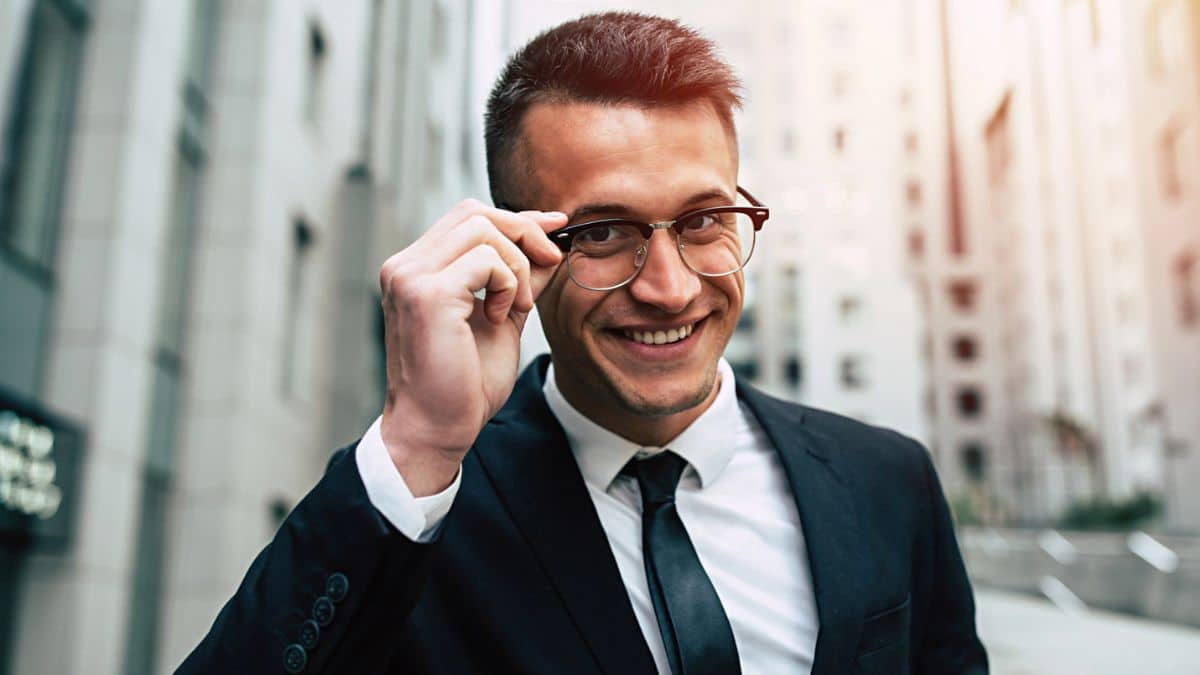 business man smirking glasses downtown