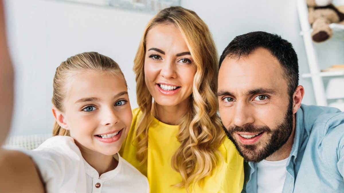 family smiling at camera