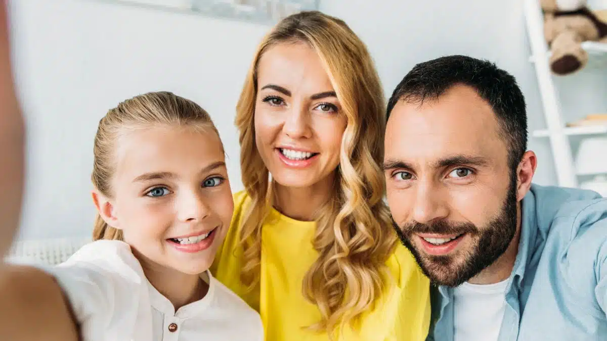 family smiling at camera