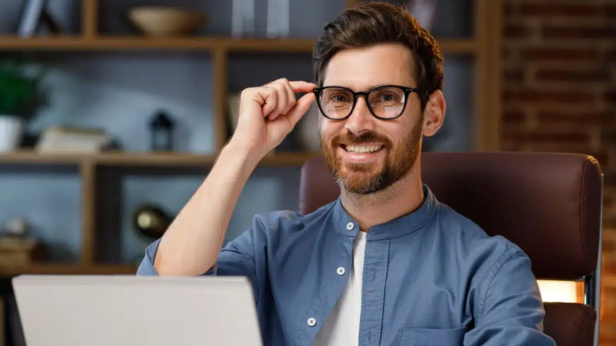 man beard glasses laptop
