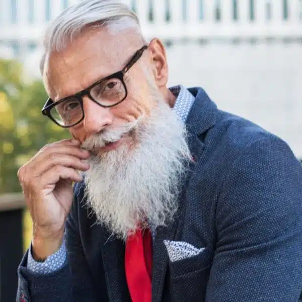 man beard glasses sitting outside