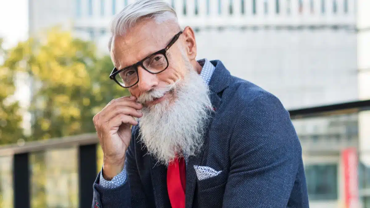 man beard glasses sitting outside