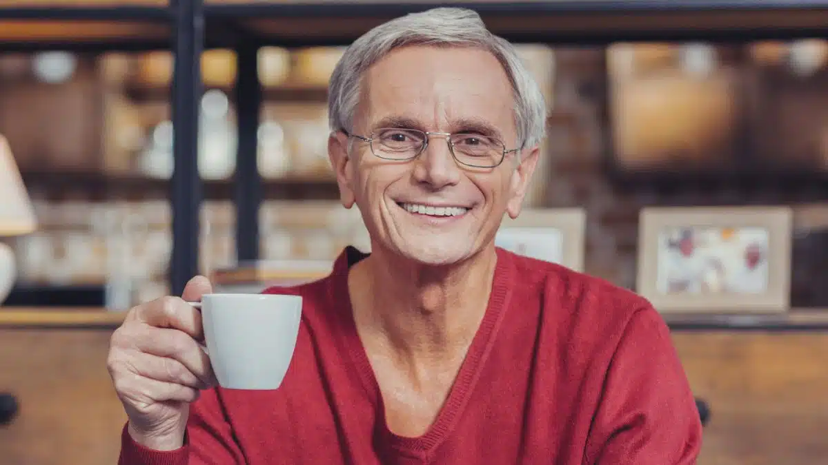 man red sweater coffee happy