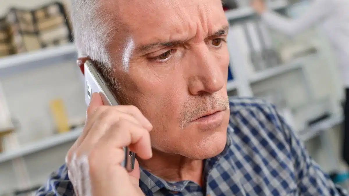 mature man on phone in office