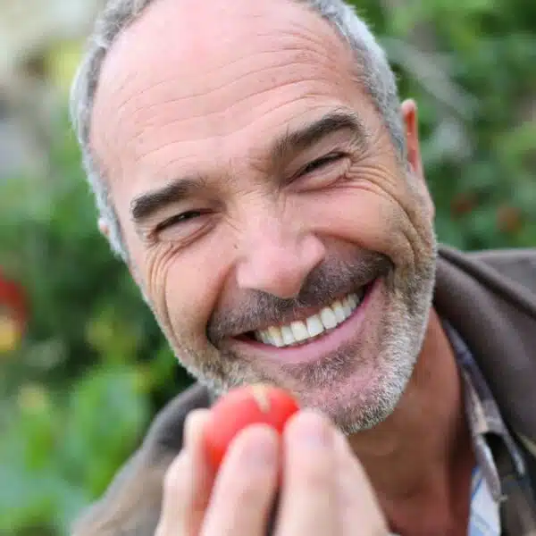 mature man smiling in the garden