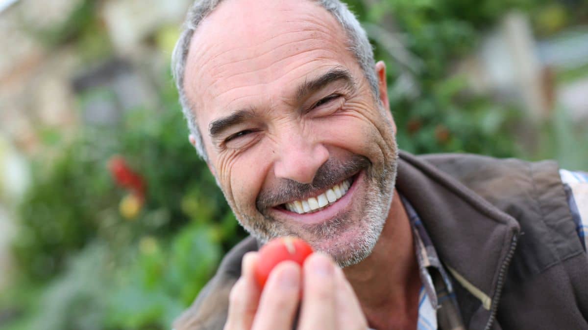 mature man smiling in the garden