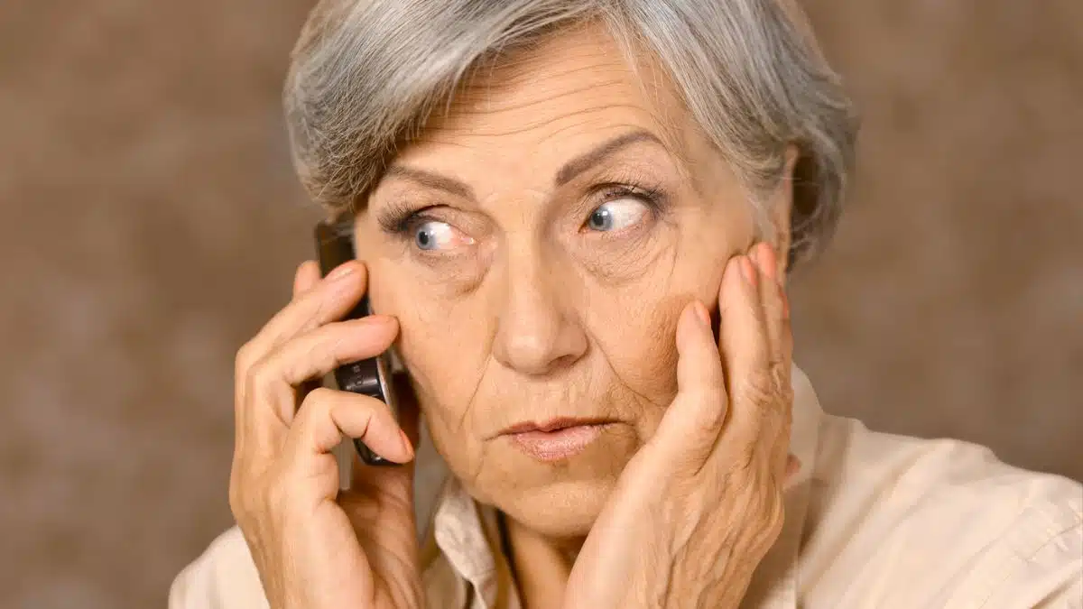 senior woman phone thinking