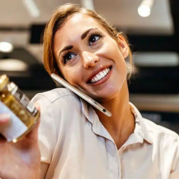 woman on phone grocery shopping
