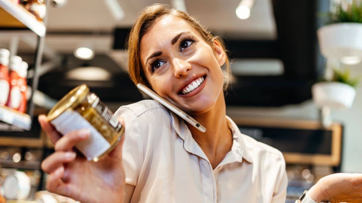 woman on phone grocery shopping